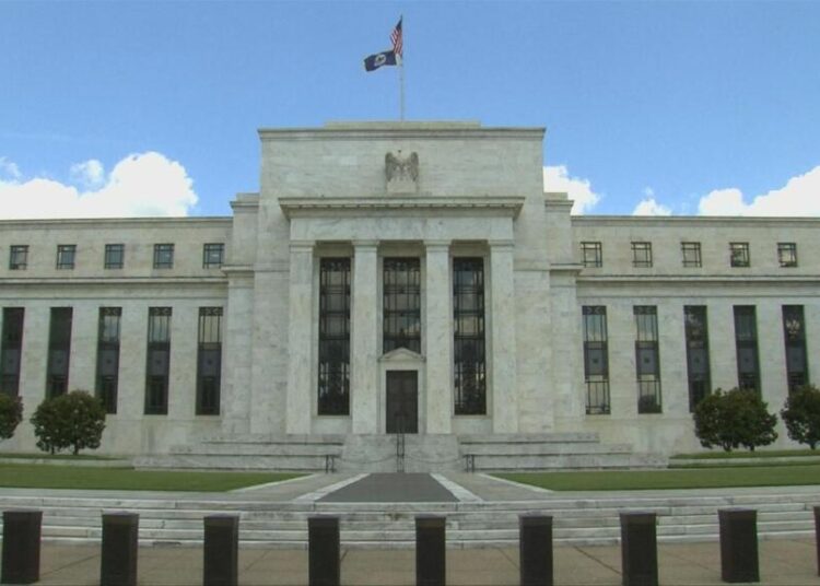 US Federal Reserve holds rates steady, but warns of inflation and slowing growth