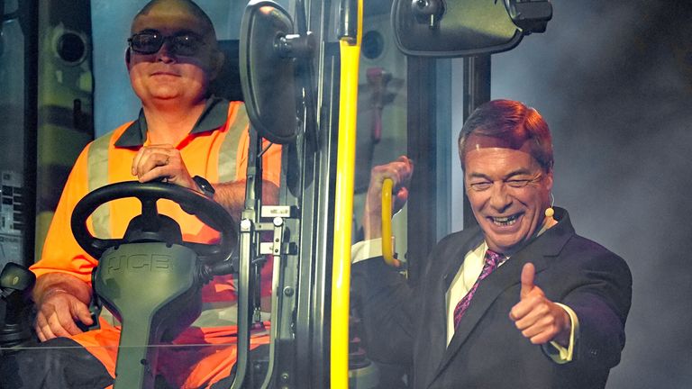 Nigel Farage arrives on a JCB digger. Pic: PA