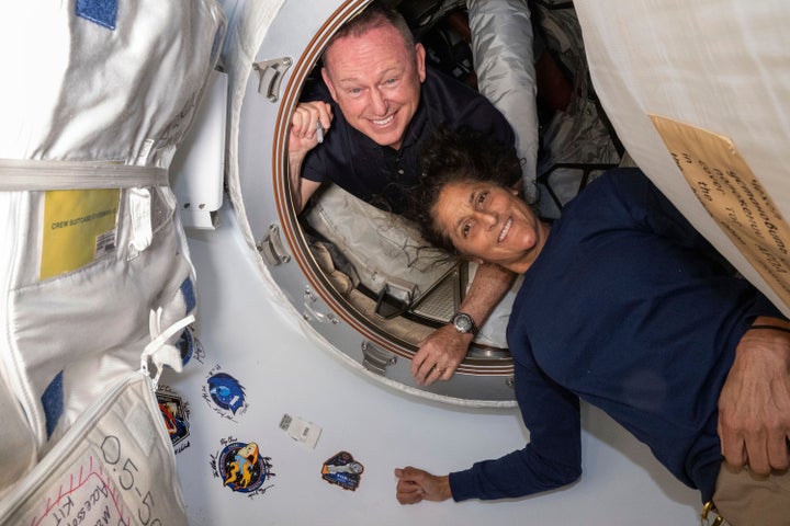 Boeing Crew Flight Test astronauts Butch Wilmore, left, and Suni Williams pose for a portrait on the International Space Station's Harmony module and Boeing's Starliner spacecraft on June 13.