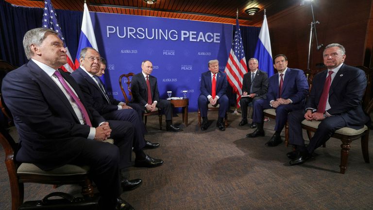 The two leaders flanked by their support staff. Pic: AP