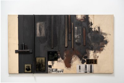 A mixed-media collage painting with various found images and objects affixed to an off-white canvas that has been painted in parts black and brown.