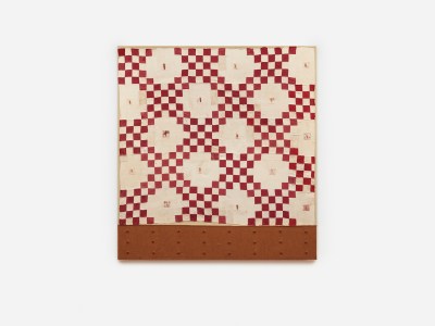 A patchwork pattern in red and white that looks like a quilt.