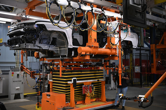A battery is installed in an electric Hummer at General Motors’ plant in Detroit