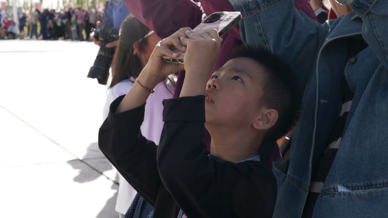 A boy watches the launch
