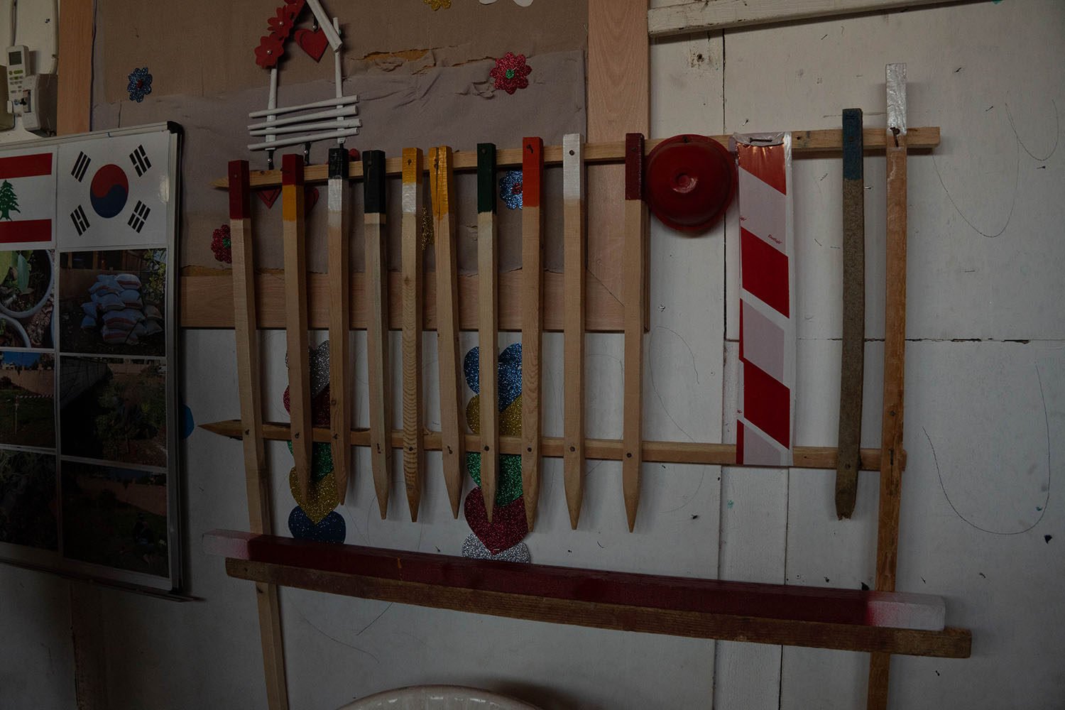 Colorful sticks and posts hang on a wall.