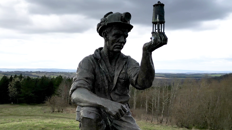 A sculpture of a miner above Ashfield