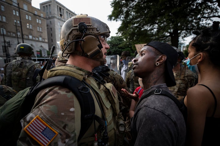 A demonstrator stares at a National Guard soldier at an anti-racist protest over the murder of George Floyd, near the White House in Washington, D.C., on June 3, 2020.
