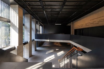 View of a reception area with a lobby and a balcony, as seen from the staircase.