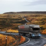 A Crozier truck driving through a bucolic countryside.