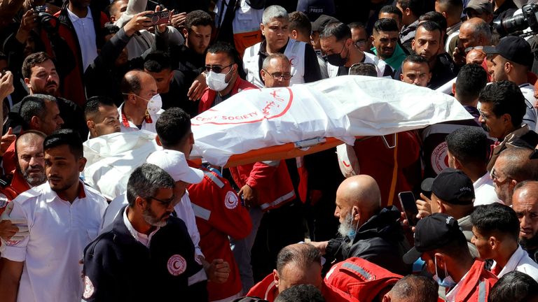 Palestinians gather around a body as they mourn medics, who came under Israeli fire while on a rescue mission, after their bodies were recovered, according to the Red Crescent, at Nasser hospital in Khan Younis in the southern Gaza Strip March 31, 2025. REUTERS/Hatem Khaled
