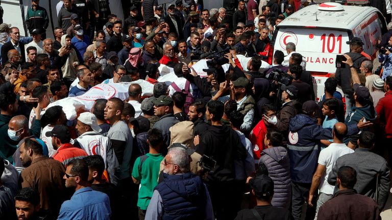 Palestinians gather around a body as they mourn medics, who came under Israeli fire while on a rescue mission, after their bodies were recovered, according to the Red Crescent, at Nasser hospital in Khan Younis in the southern Gaza Strip March 31, 2025. REUTERS/Hatem Khaled
