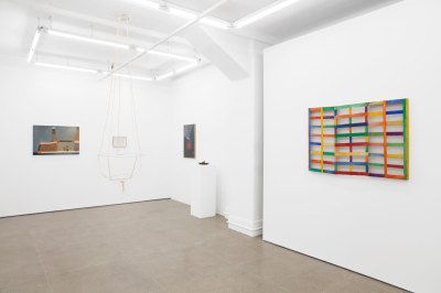 View of a gallery exhibition showing artworks of different mediums.