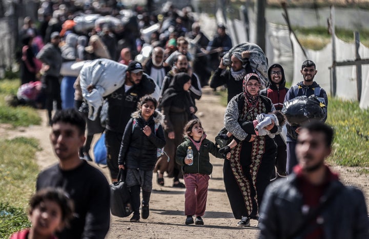 Displaced Palestinians flee from Rafah to Khan Younis as the Israeli army continues to attack southern Gaza, on March 23, 2025.