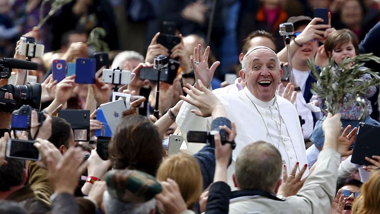 FILE PHOTO: Pope Francis waves at the end of the Palm Sunday mass at Saint Peter's Square at the Vatican, March 20, 2016. REUTERS/Tony Gentile/File Photo
