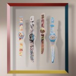 Four watches hang on a wall.