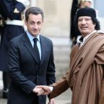 Two men shaking hands for the camera.