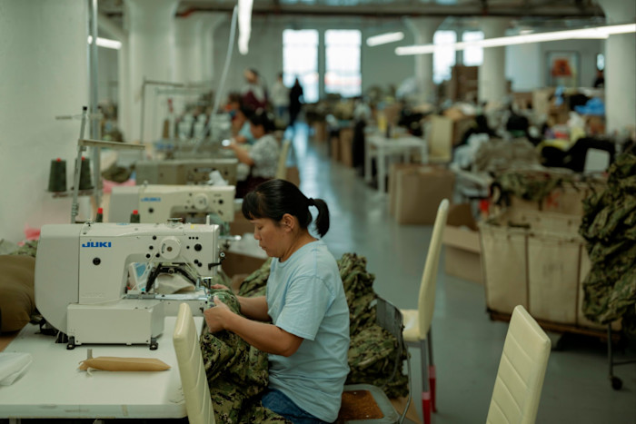 Workers at sewing machines at NYES