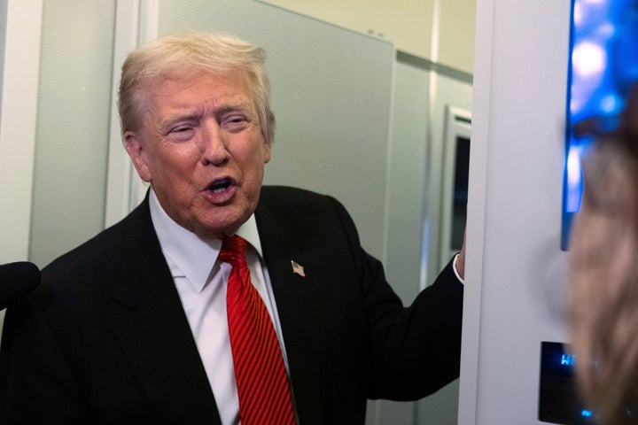 President Donald Trump speaks to reporters Sunday on board Air Force One on his way back to the White House from a weekend trip at his Mar-a-Lago estate in Palm Beach, Florida.