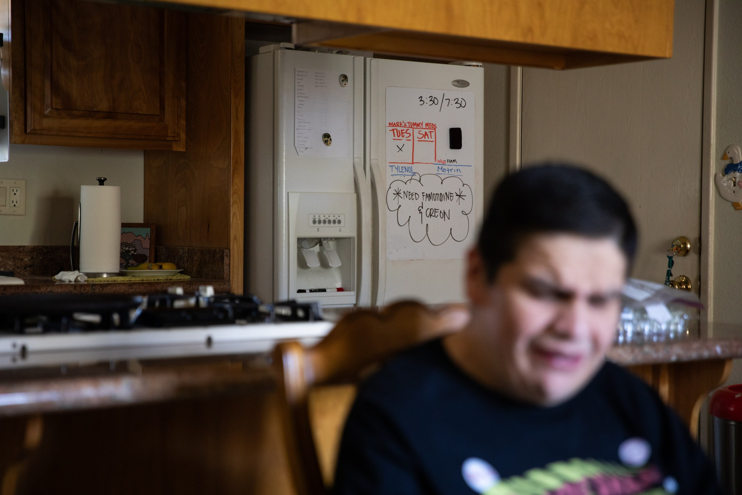Mark sitting in a chair with the kitchen behind him.