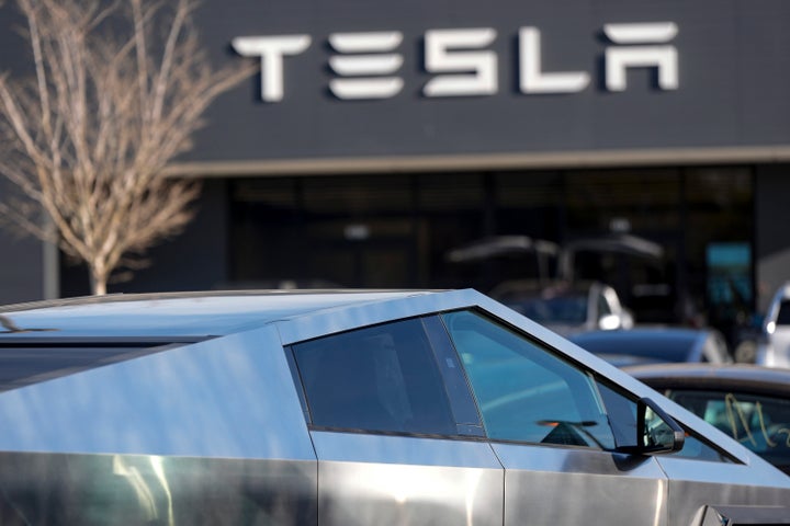 A Tesla Cybertruck and other Telsla vehicles sit at a dealership, Wednesday, March 19, 2025, in Kennesaw, Ga. (AP Photo/Mike Stewart)