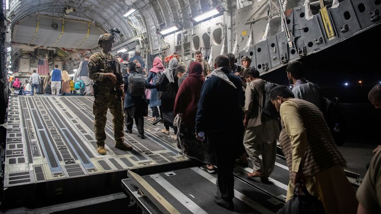 People board a US evacuation flight in Kabul.