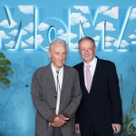 Two men standing beneath the MoMA logo.
