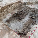 A deep tomb with ancient remains at the bottom.