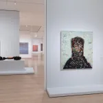 A gallery filled with abstract paintings.