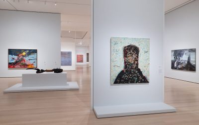 A gallery filled with abstract paintings.