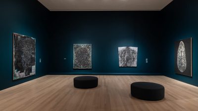 A gallery with abstract paintings.