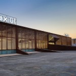 A modern rectangular building with floor to ceiling glass windows.